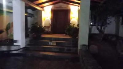 a front door of a house at night with lights at Klipspringer Lodge in Nelspruit