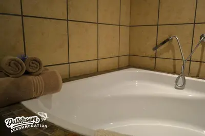 a bath tub with two towels on top of it at Lakeside 1 in Dullstroom
