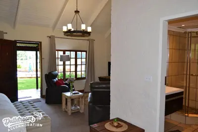 a living room with a couch and a table at Lakeside 1 in Dullstroom