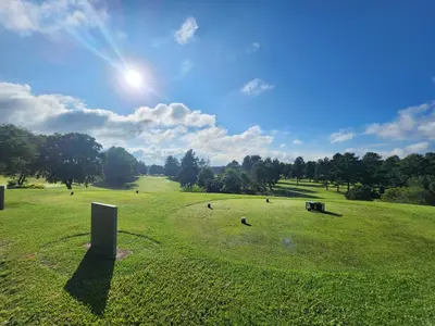 a large field of grass with the sun in the sky at Maclarty House - Golf Estate Villa in White River