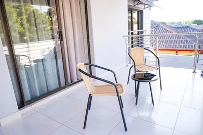 two chairs and a table on a balcony at The Luthe in Thohoyandou