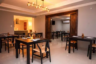 a restaurant with tables and chairs in a room at The Luthe in Thohoyandou