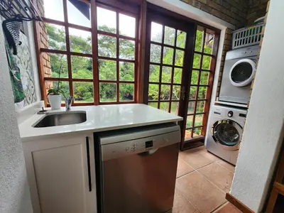 a kitchen with a sink and a washing machine at Golf Estate Vacation Property - Poseidon's Knoll in White River