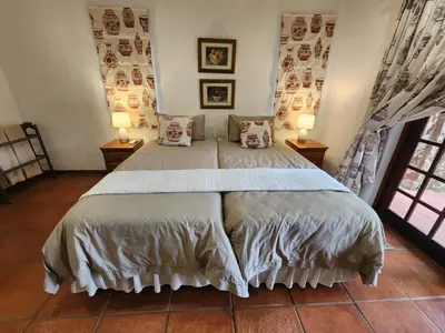 a bedroom with a large bed with two lamps at Golf Estate Vacation Property - Poseidon's Knoll in White River