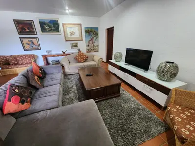 a living room with a couch and a flat screen tv at Golf Estate Vacation Property - Poseidon's Knoll in White River