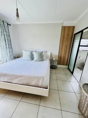 a white bedroom with a white bed in a room at 126Theblyde in Pretoria