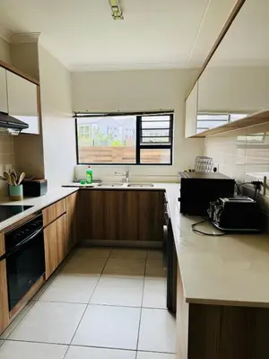 a large kitchen with a sink and a window at 126Theblyde in Pretoria