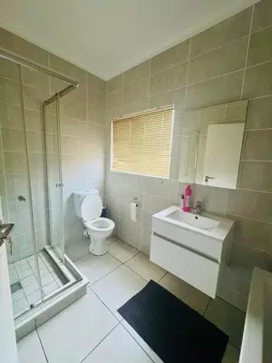 a bathroom with a toilet and a sink and a shower at 126Theblyde in Pretoria