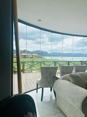 a living room with a couch and chairs and a large window at View at 81 in Hartbeespoort
