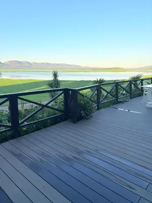 a wooden deck with a view of the water at View at 81 in Hartbeespoort