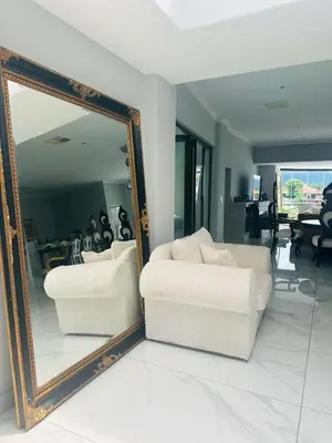 a living room with a mirror and a couch at View at 81 in Hartbeespoort