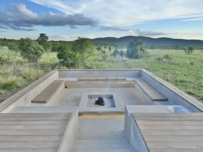 an outdoor fire pit in the middle of a field at Gweda Lodge in Ouklip