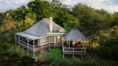 an aerial view of a house with a thatch roof at Xidulu Safari Lodge - Makalali in Makalali Game Reserve