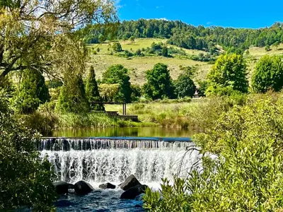 a waterfall in the middle of a river at Stone Creek Mountain Lodge in Dullstroom