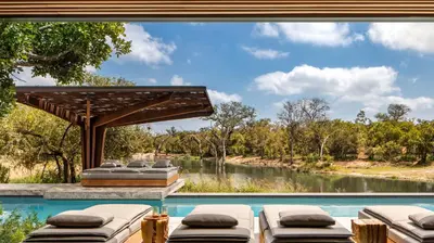 a pool with a view of a river at Cheetah Plains Private Game Reserve in Sabi Sand Game Reserve