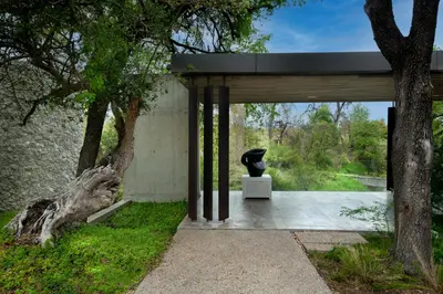 a modern house with a black vase sitting on a sidewalk at Cheetah Plains Private Game Reserve in Sabi Sand Game Reserve