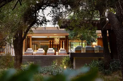 a house with a bunch of chairs in front of it at Cheetah Plains Private Game Reserve in Sabi Sand Game Reserve