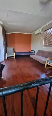 a room with two beds and a wooden floor at Nerina 662 in Leeupoort
