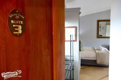 a door to a room with a bedroom with a bed at Cherry Grove 3 in Dullstroom