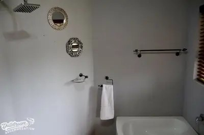 a bathroom with a white toilet and a mirror at Cherry Grove 3 in Dullstroom