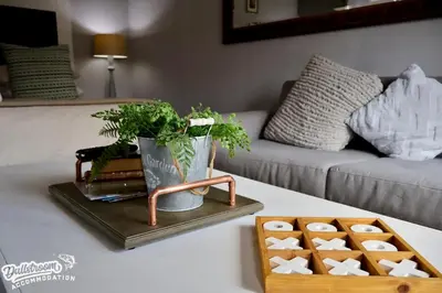 a living room with a table with a tray and a couch at Cherry Grove 3 in Dullstroom