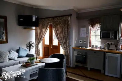 a living room with a couch and a table at Cherry Grove 3 in Dullstroom