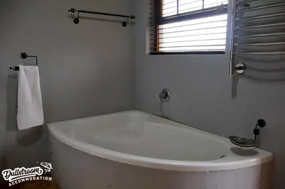 a white bath tub in a bathroom with a window at Cherry Grove 3 in Dullstroom
