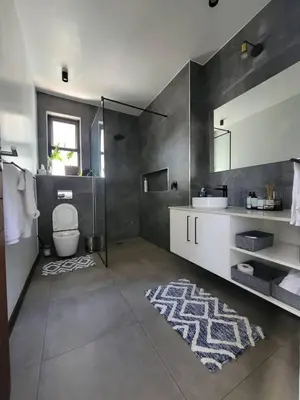 a bathroom with a sink and a toilet and a mirror at The Cottage in Secured Estate in Pretoria