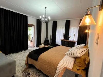 a bedroom with a large bed in a room at Labacht Home with The view in Dullstroom