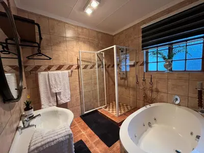a large bathroom with a tub and a shower at Labacht Home with The view in Dullstroom