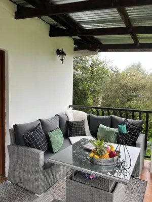 a living room with a couch and a table at Labacht Home with The view in Dullstroom
