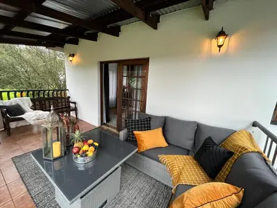 a living room with a couch and a table at Labacht Home with The view in Dullstroom