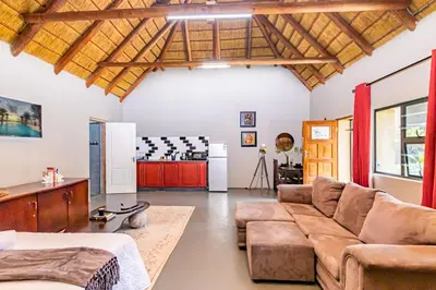a living room with a couch and a table at Amani Peaceful Home in Centurion