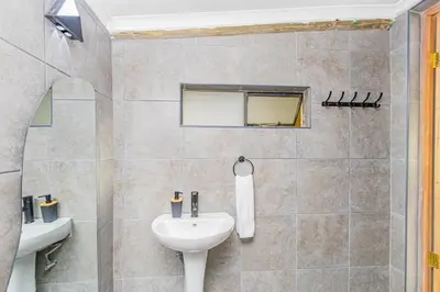a bathroom with a sink and a toilet at Amani Peaceful Home in Centurion