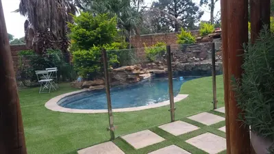 a swimming pool in a yard with a fence at Amani Peaceful Home in Centurion