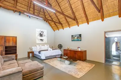 a living room with a bed and a couch at Amani Peaceful Home in Centurion