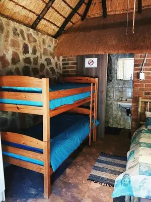 a bedroom with two bunk beds in a room at Thaba Tshwene Game Farm in Modimolle
