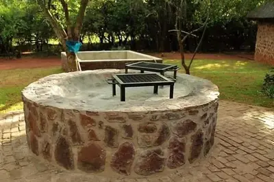 a bench sitting on top of a tree stump at Thaba Tshwene Game Farm in Modimolle