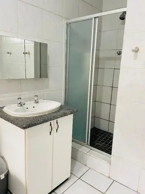 a bathroom with a sink and a shower at Inspire living home in Kempton Park