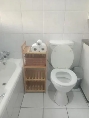 a bathroom with a toilet and a sink and a tub at Inspire living home in Kempton Park