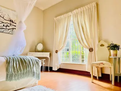 a bedroom with a bed and a window at Patches Place in Pretoria
