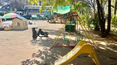 a playground with a yellow slide and a swing at Patches Place in Pretoria