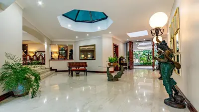 a lobby with a statue in the middle of it at Villa Christies at 32 on Russell in Nelspruit