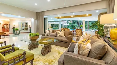 a living room with couches and a glass table at Villa Christies at 32 on Russell in Nelspruit