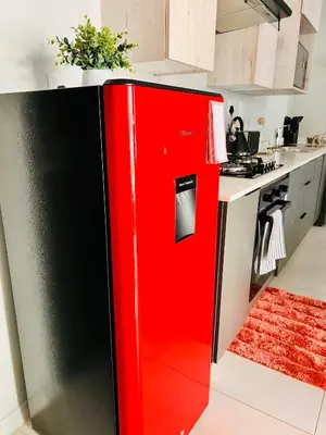 a red and black refrigerator in a kitchen at Stunning 1 bed in Midrand at 93 On New Estate in Midrand