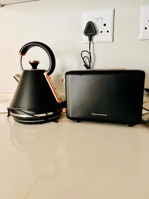 a tea kettle and a laptop computer on a counter at Stunning 1 bed in Midrand at 93 On New Estate in Midrand