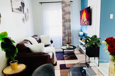 a living room with a couch and a glass table at Stunning 1 bed in Midrand at 93 On New Estate in Midrand