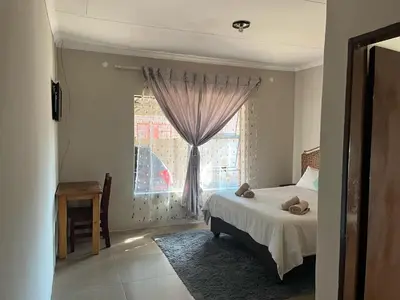 a bedroom with a bed and a window at AS contractors accommodation in Erasmus