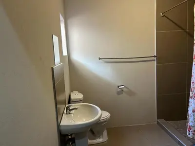a bathroom with a sink and a toilet and a shower at AS contractors accommodation in Erasmus