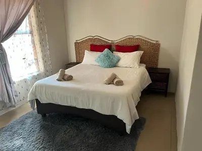 a bedroom with a large bed with slippers on it at AS contractors accommodation in Erasmus
